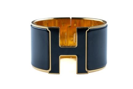 HERMES. 
Wide "Clic-clac" cuff bracelet in gold-pl