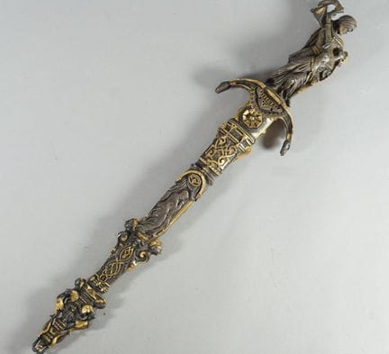 Dagger with a chiseled bronze handle decorated wit
