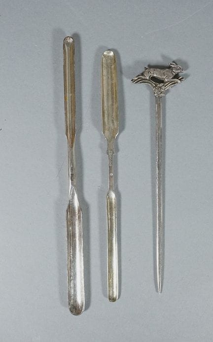 Two marrow spoons and a silver plated metal skewer