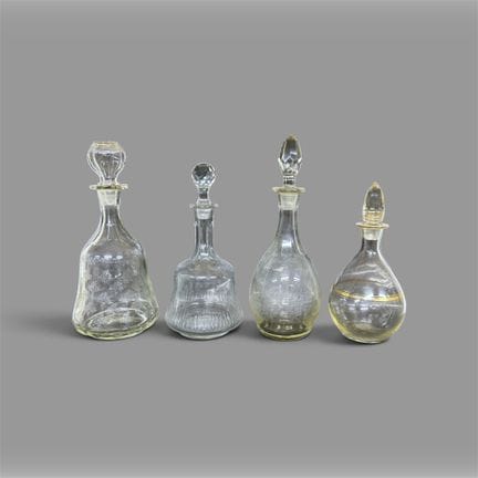 FOUR glass bottles. Signs of use and handling; two