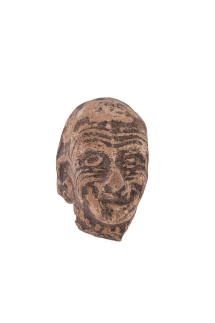 Head made of antique terracotta. 6.3 cm high.