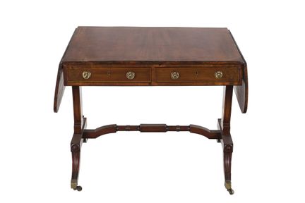 Regency-style drop-leaf table in carved and mahoga