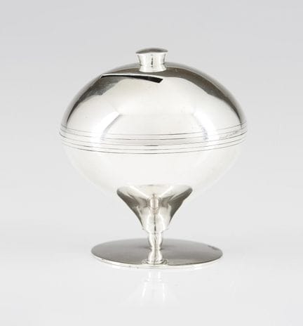 A silver money box
Silver
Spinning-top shaped, wit