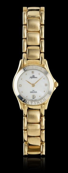 Un reloj de pulsera DELMA
Caja con brazalete de or