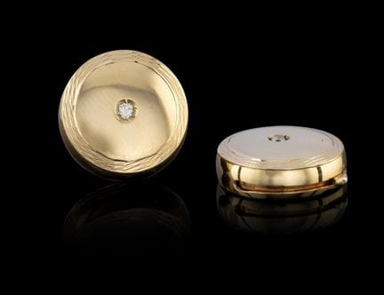 A pair of diamond and gold cufflink covers
Gold, f