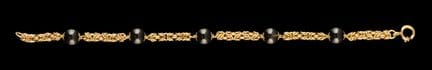 Una pulsera de ónix y oro
Oro, ley 0,800
Cadena sa