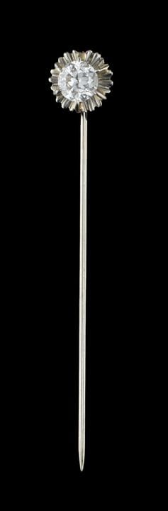 Un alfiler de corbata con diamante
Oro blanco, ley