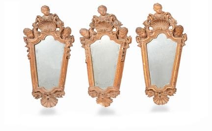 THREE TERRACOTTA WALL-MOUNTED MIRRORS IN THE STYLE