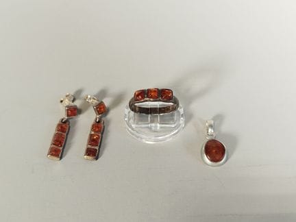 一套由925银制成的戒指，镶嵌三颗方形琥珀凸面宝石；一对吊坠耳环，镶嵌与戒指款式相同的方形凸面琥珀；