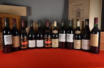 A collection of twelve bottles of red wine in thei