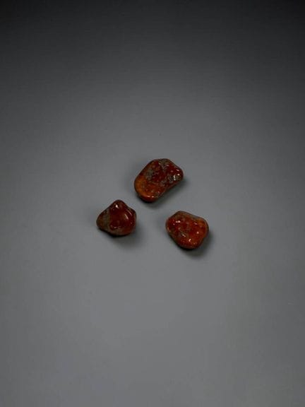 Three polished hessonite garnets, approximately 2.