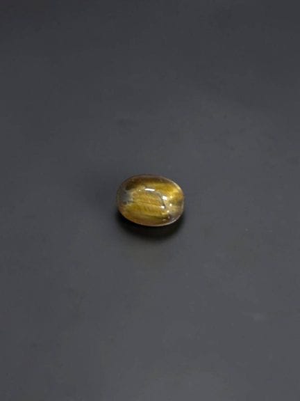 Tiger's eye cabochon, 8 × 6 mm, approximately 1.08