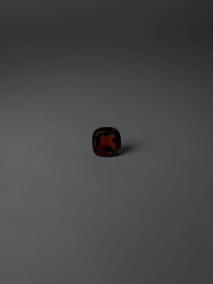 Cushion-cut garnet, 4.9 mm, approximately 0.54 car