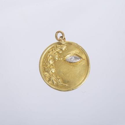 18K yellow gold medal, chiseled with a “leaf” desi