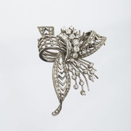 An 18K white gold brooch sculpted in the shape of 