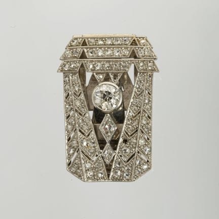 Art Deco lapel pin in 18K white gold with a centra