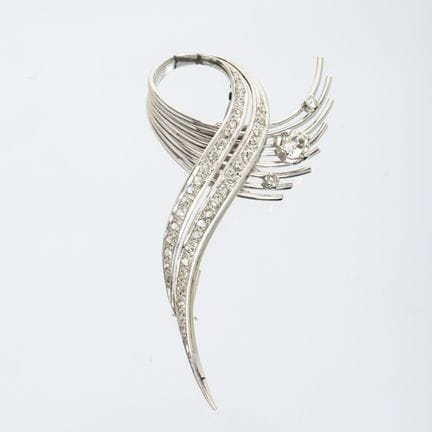 An 18K white gold brooch sculpted in the shape of 