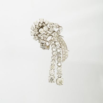 An 18K white gold brooch sculpted in the shape of 
