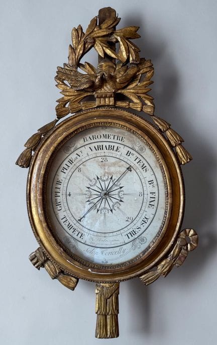 Gilded wooden barometer with a pediment carved wit