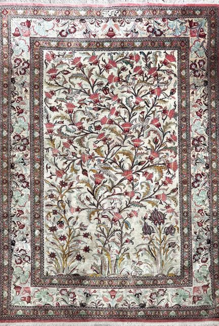 Qom wool rug with a rich design of birds and flowe