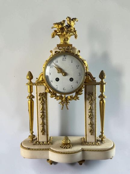 A white marble and gilded bronze pendulum clock wi