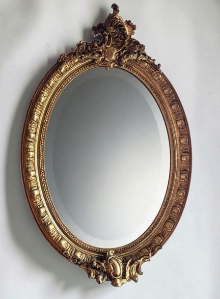 Oval beveled mirror made of wood and gilded stucco