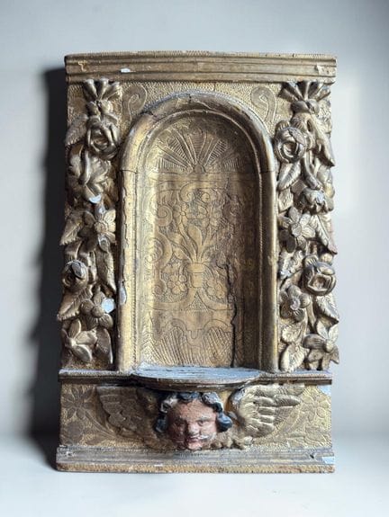 A carved and gilded wooden tabernacle, adorned wit