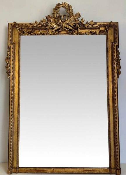 Mirror with beveled wooden edges and gilded stucco