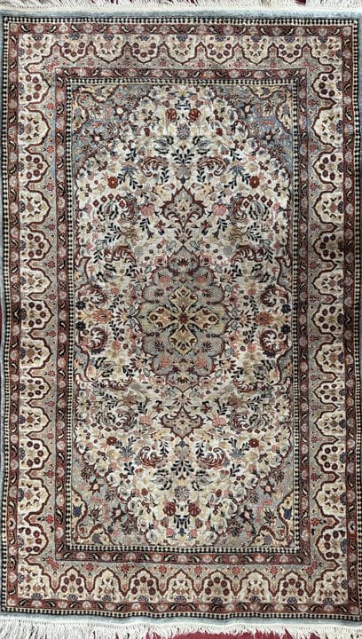 Oriental wool rug with geometric patterns on a cre