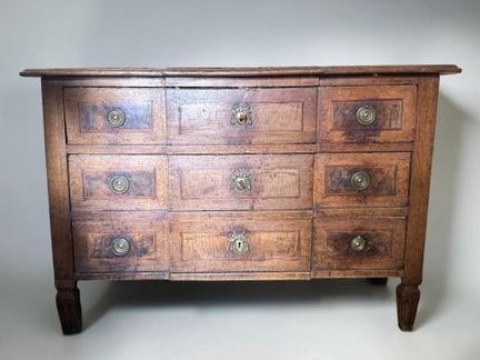 Natural wood chest of drawers with a central reces