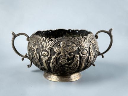 Cup on a pedestal with two handles, made of silver