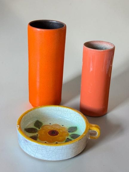 Set of two cylindrical vases in orange-glazed cera