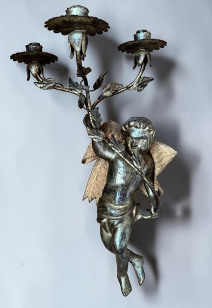 Pair of carved wooden wall sconces featuring putti