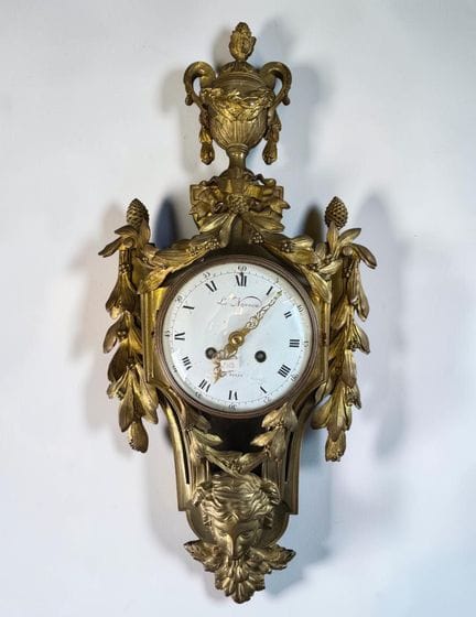 Chiseled and gilded bronze wall clock with a desig