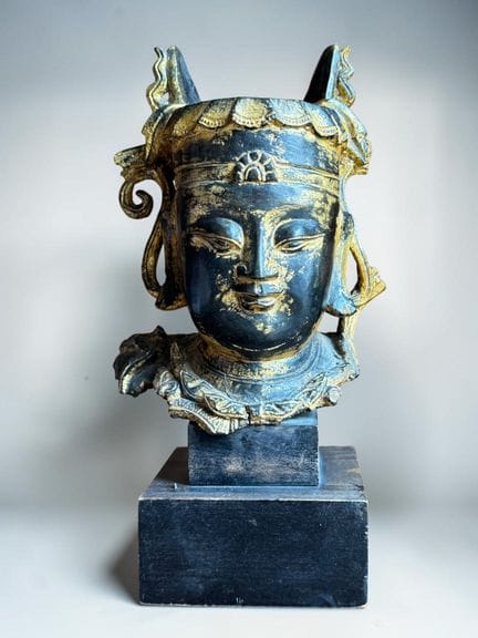 Bronze Bodhisattva head with a brown patina and tr