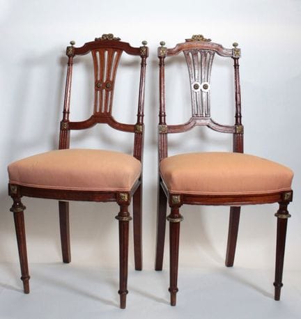 Pair of carved wooden chairs with gendarme-hat-sty
