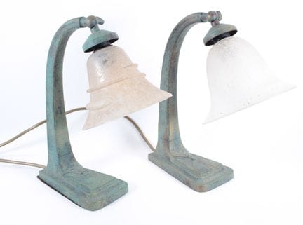 Pair of bronze lamps with a green patina, featurin