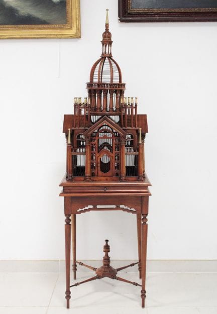 Carved wooden birdcage with architectural decorati