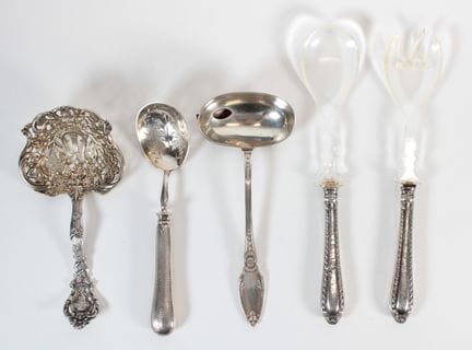 A set of silver and silver-clad cutlery comprising