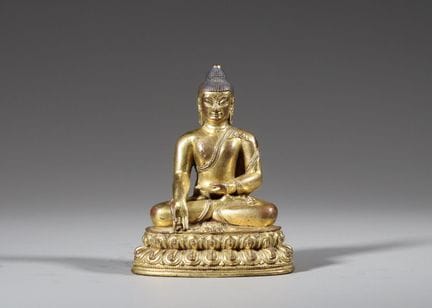 Une figure assise en bronze doré représentant le T