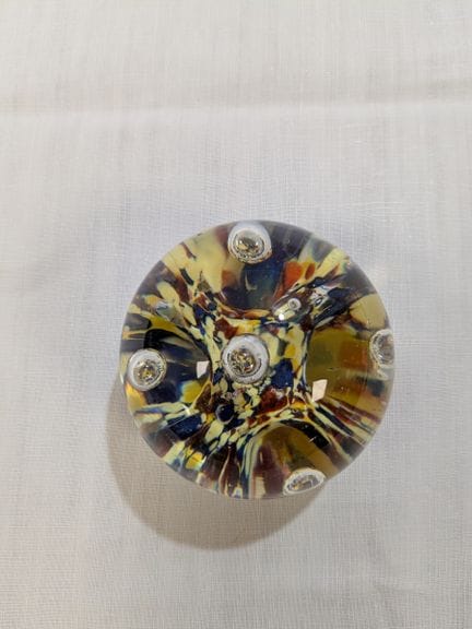 Glass ball paperweight, sulfur-colored. Diameter: 