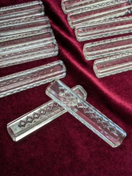 Set of twelve engraved glass knife holders. Length