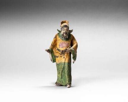 Decorative stoneware piece with yellow, green, and