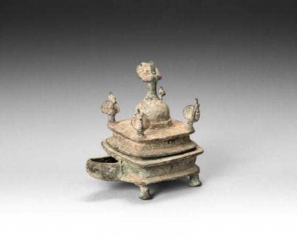 Covered four-legged oil lamp; the body features a 