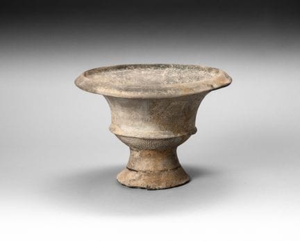 Black terracotta stemmed cup with an incised and i