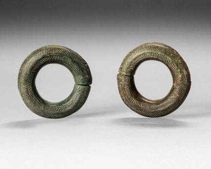 Two bronze bracelets decorated with chevron and sc
