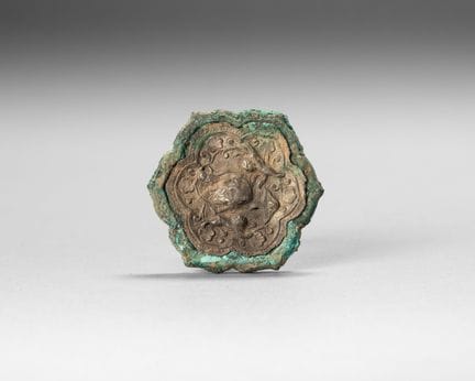 Small bronze mirror in the shape of a flower, with