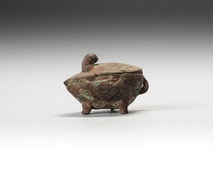 Bronze tripod pot in a leaf-shaped design, with a 