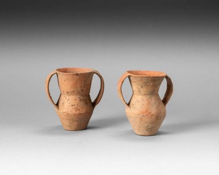 Two small red terracotta jars, with a diamond-shap