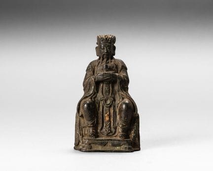 Bronze group depicting a Taoist deity seated on a 